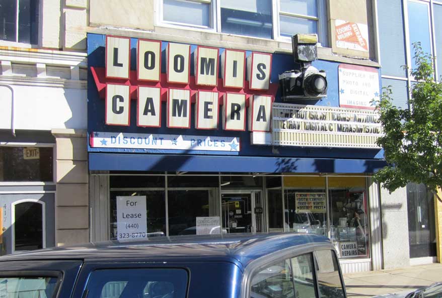 American Sign Museum restores storefront camera shop signage.