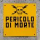 This Italian sign, which translates to “danger of death,” speaks the universal language of hazard signs: bright yellow paired with a bold black font, adorned with a skull and bolts of electricity.