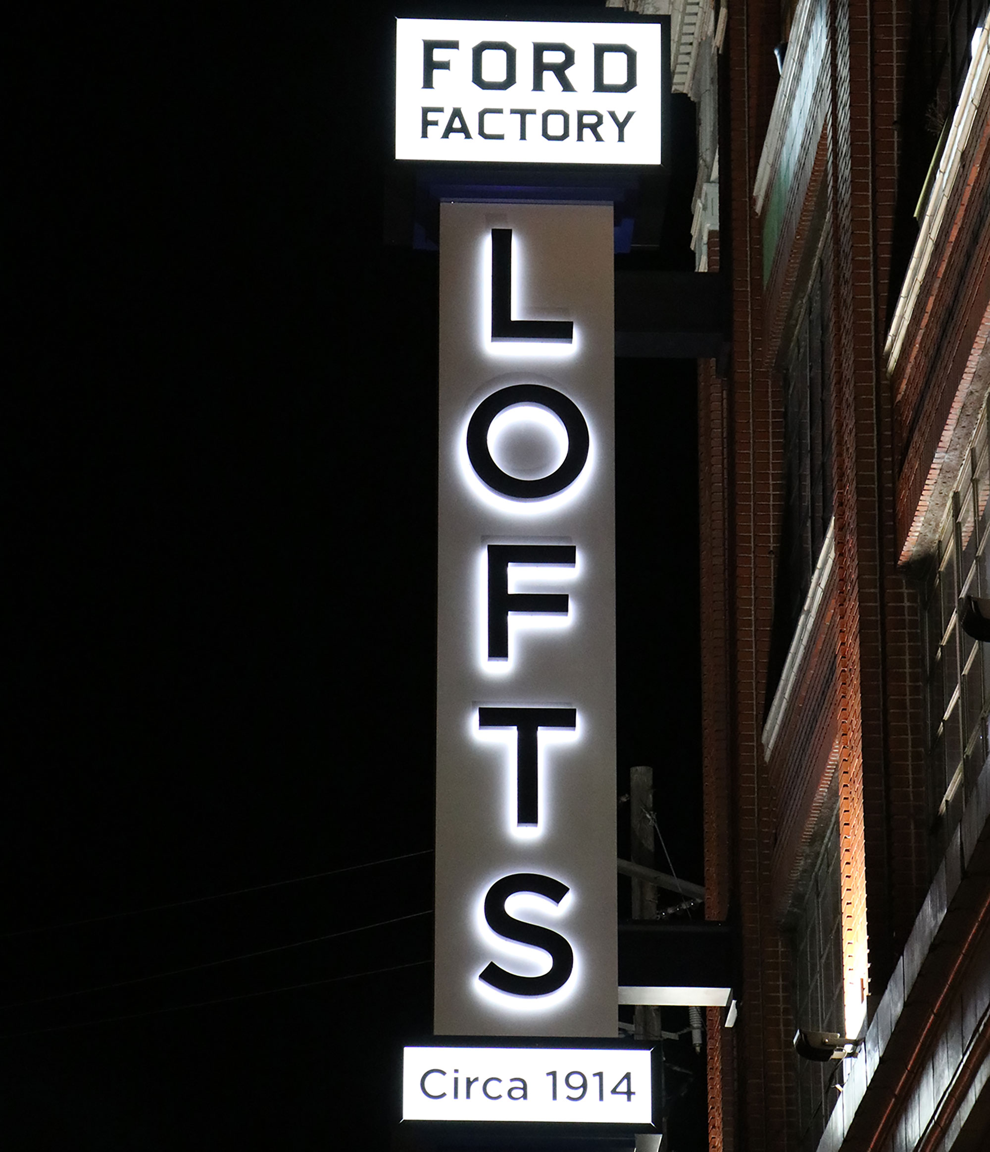 A simple vintage logo and I-beam design provide the feel of the original Ford Motor plant for these loft apartments.