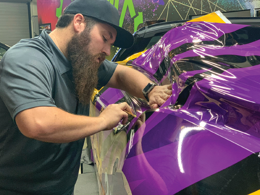 Adam (above) and the Wrapix Imaging team, incuding installer Alex (below), have benefitted from analyzing and refining their wrap routines to maximize efficiency and minimize stress.