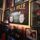 This lightweight, portable, battery-operated "Talk Ville" sign covers a neon one in this studio.