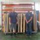 PIP Triad’s 3M Preferred Installers Jody Belangia (left) and Brandon Williams (right) standing in front of several rolls of 3M Di-Noc used for past jobs.