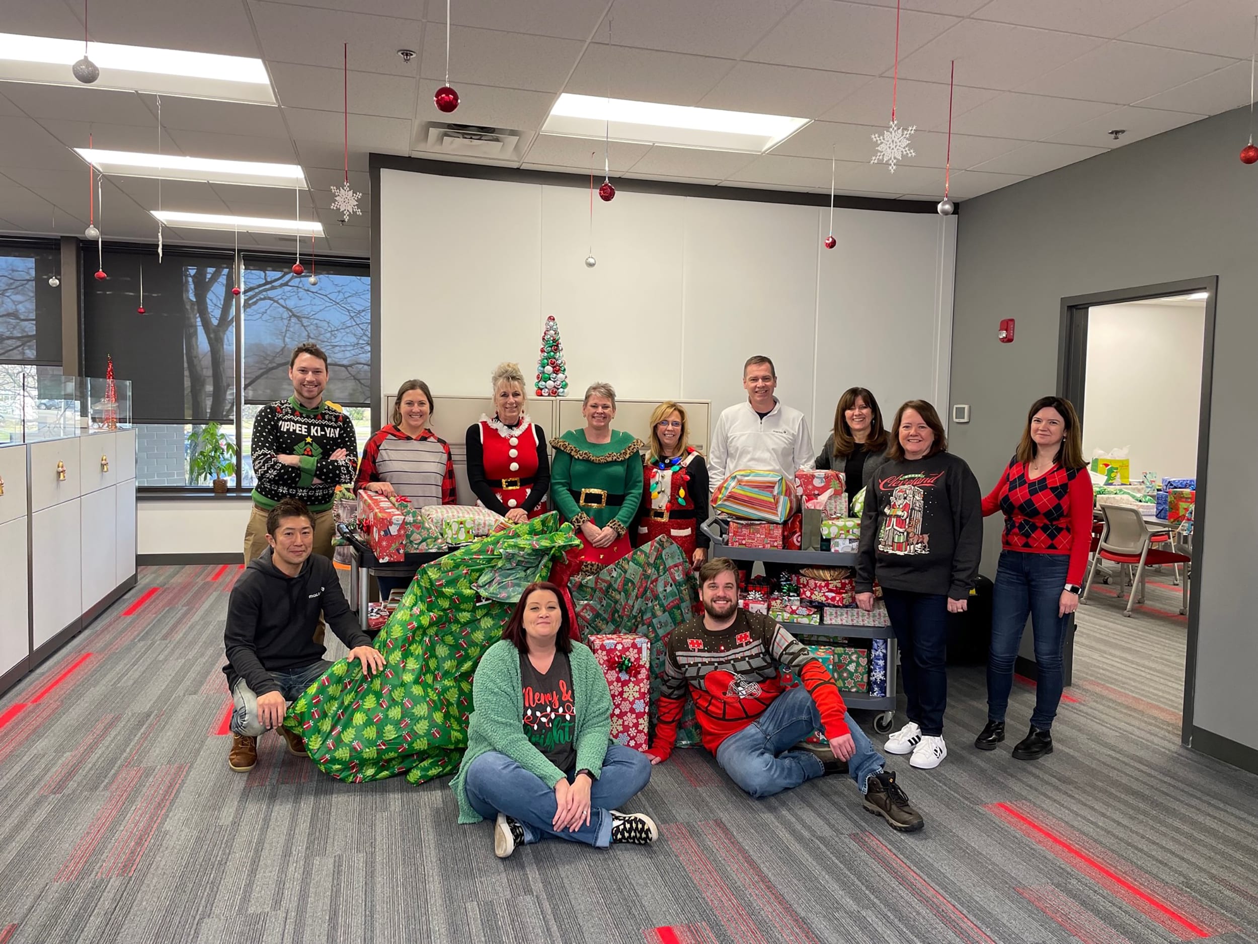 Mactac employees taking a break from volunteering to help with Akron Children’s Hospital ‘Adopt A Family’ gift drive.