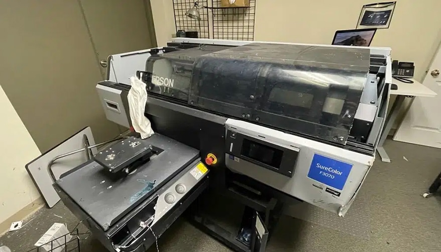 The shop's Epson DTG printer was destroyed during the theft.