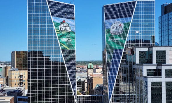 Sleek Advertising Ltd. printed and installed promotional graphics for the 2022 Grey Cup Festival all over Regina, but nowhere as spectacularly as their window work on the McCallum Hill Centre Towers.